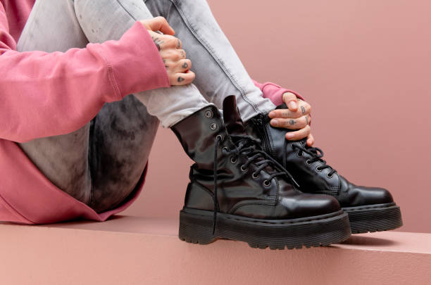 Sitting woman wearing combat boots