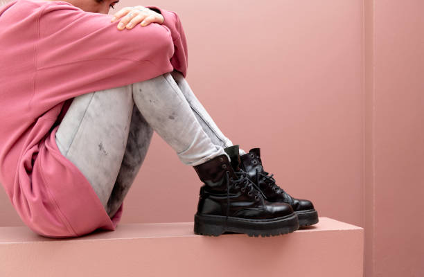 istock Sitting woman wearing combat boots 2156898510