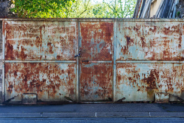 istock Rusted Metal Gate with Padlock on Urban Street 2156898928