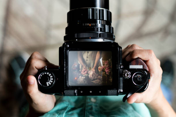 Florist arranging flowers on a professional camera