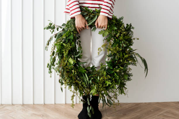 Woman carrying a fresh Christmas wreath