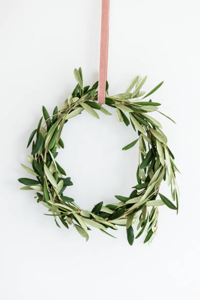 istock Eucalyptus Christmas wreath hanging on a white wall 2156900050