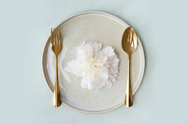 istock Beautiful paeonia snow board on a plate with golden spoon and fork 2156900065