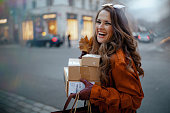 smiling-stylish-woman-in-brown-trench-coat-with-parcels.jpg?b=1&s=170x170&k=20&c=2UDYlRiRi8fbWGjfFp9_PjvOAefMi9H5opTgkIEoUmQ=