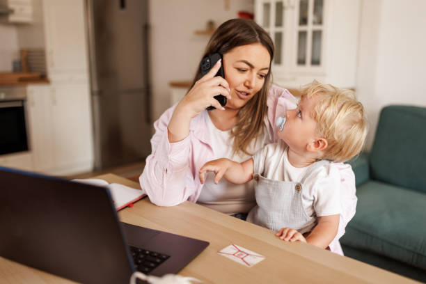 istock Working mother with baby boy at home 2156900850