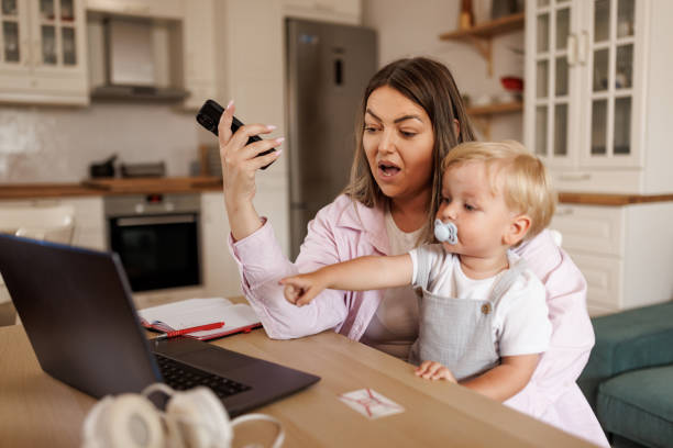 istock Working mother with baby boy at home 2156901212