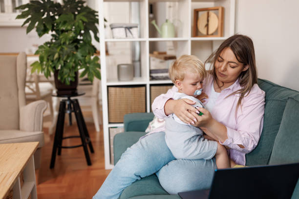istock Devoted young mother comforting baby son at home 2156902037