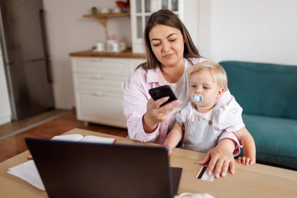 istock Working mother with baby boy at home 2156903309