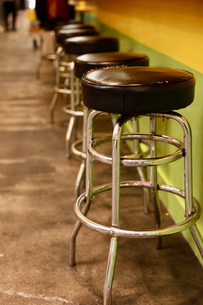 istock Old fashioned barstools lined up to the bar 2156905025