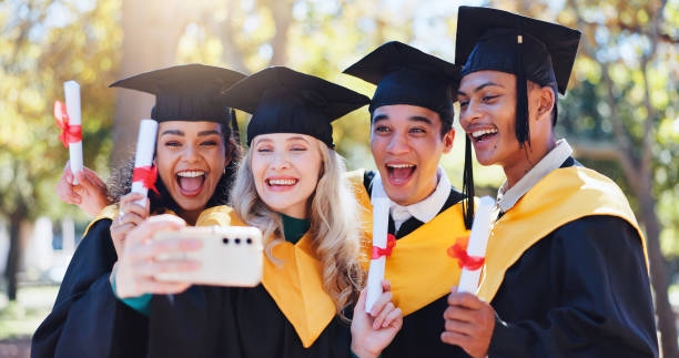 istock Happy students, graduation and celebration with selfie for memory, certficate or diploma in nature. Group of young and excited graduates with smile in photography, picture or moment for qualification 2156905645