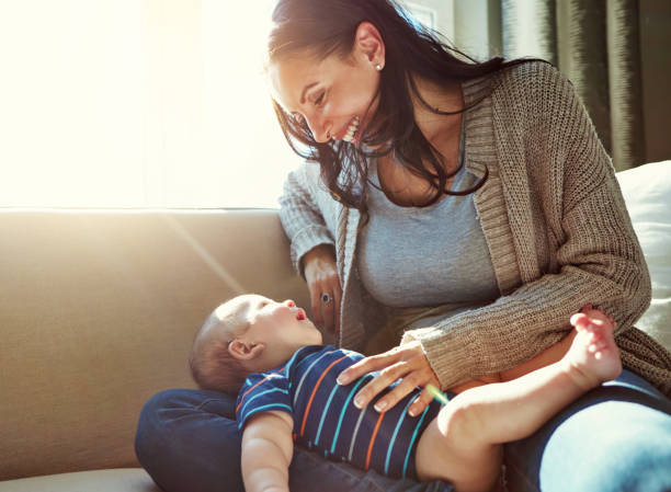 istock Happy, mother and baby on sofa relax on weekend for love, bonding and relationship development in home. Care, woman and child together on couch in summer for safety, support or playing in living room 2156907378