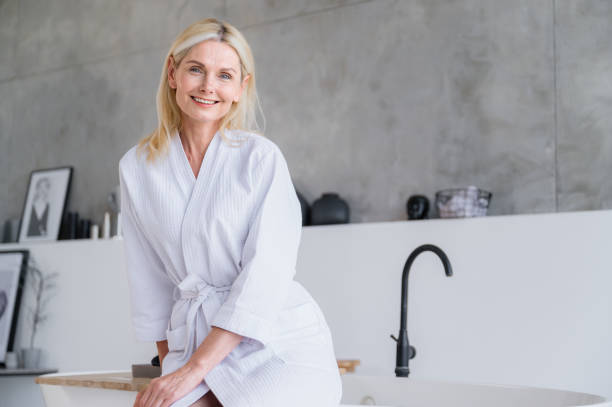 istock Smiling woman waiting on spa, wellness procedures in modern bathroom 2156908031