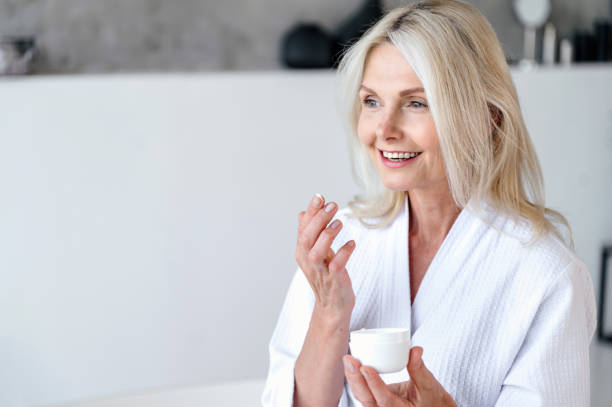 istock Senior woman using natural moisturizing for daily routine 2156908057