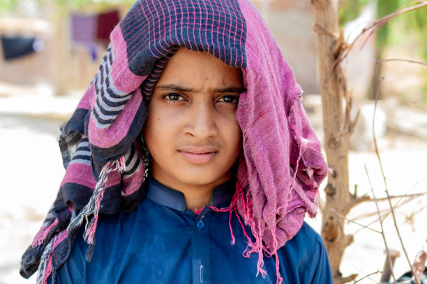 istock boy covers his head from sun's heat in summer 2156908302