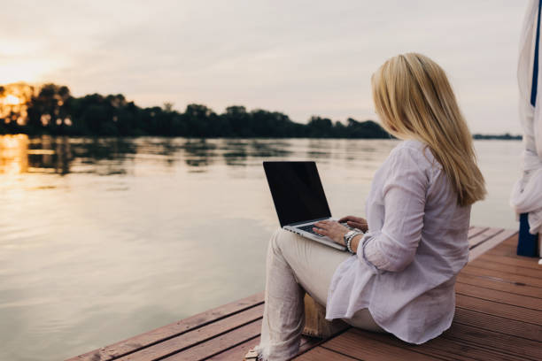 istock One mid adult woman using laptop 2156910014