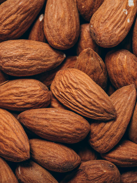 istock Almond background closeup. Almonds top view. Whole almond nuts flat lay 2156910903