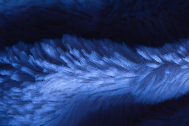 Seamless texture of blue fabric with fibers.