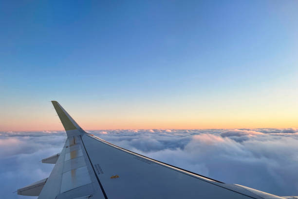 View of the magical clouds at sunset from the airplane window
