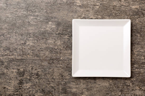 istock Top view of empty square plate on cement background. Empty space for your design 2156913523