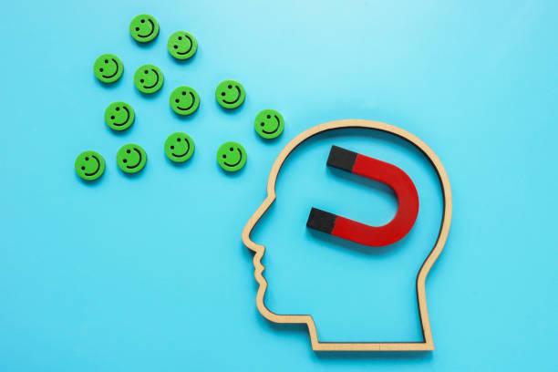 istock Positive emotions and thinking. A head with a magnet attracts happy smiley faces. 2156913783