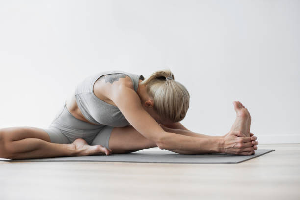 istock Woman practicing yoga, doing relaxation exercises, meditating at class 2156913875