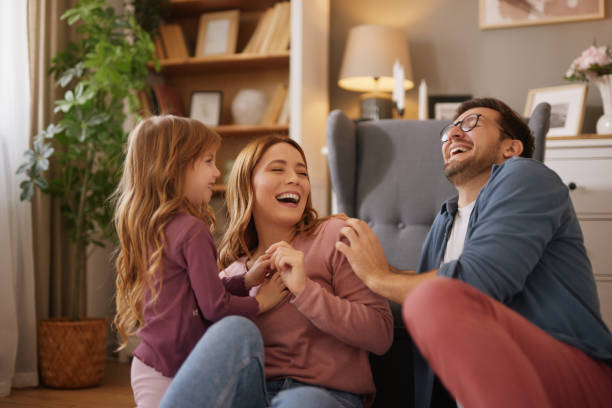 istock Parents having fun with their little daughter at home 2156914229