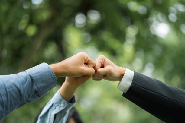 istock world environment day Global teamwork for a sustainable environment Businessmen join forces to help save the world. 2156914271