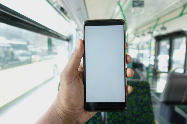 istock passenger sitting in a bus using his phone. 2156915285
