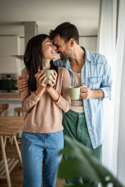 istock Young couple looking through the window in their home 2156916752