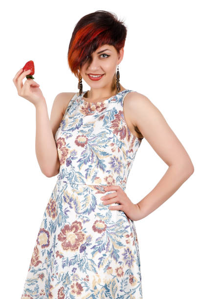 Young girl holding a strawberry. Isolated on white