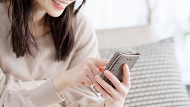istock Woman looking at smartphone in living room 2156920006