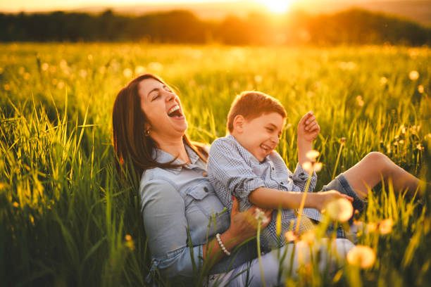 istock Nice mother and child Playing on great field at Sunset 2156922162