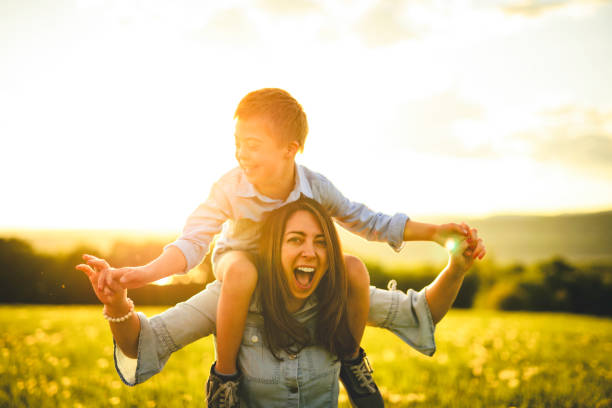 istock Nice mother and child Playing on great field at Sunset 2156922252