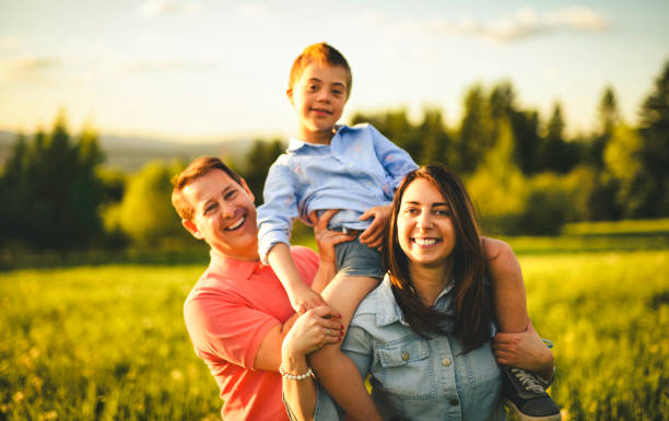 istock Beautiful father and mother with son on sunset field 2156922257
