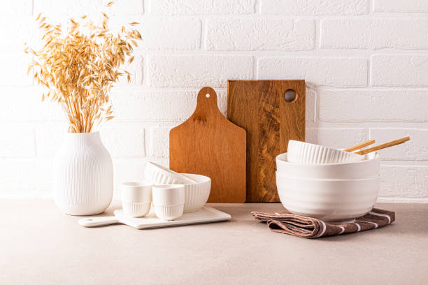 istock Beautiful kitchen background modern kitchen countertop with a set of kitchen utensils, , bowls, decorative elements. Front view. Brick white wall 2156922377