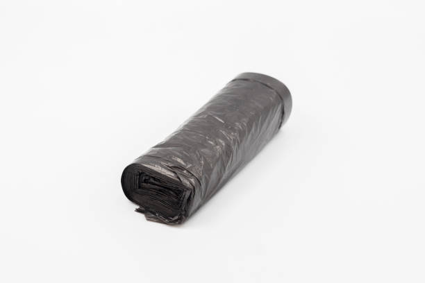 istock Black plastic garbage bags on white background, Roll of garbage bags on white background 2156925694