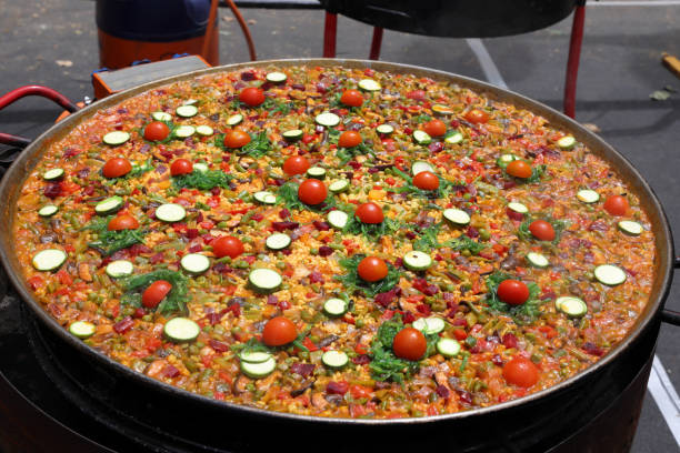 Delight in a colorful Valencian paella featuring tender chicken and fresh vegetables.