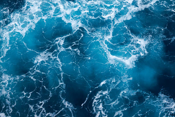 istock Ocean water background with foam. Ocean water splash. Not a calm 2156926926