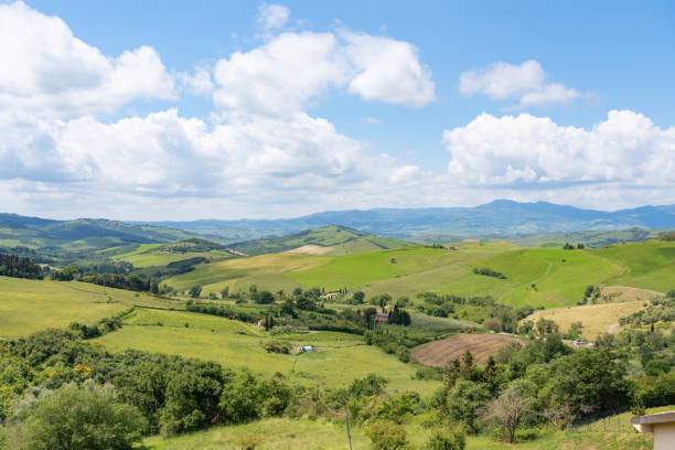 Picturesque tranquil view of agricultural hilly landscape against clear sky during sunny day at countryside