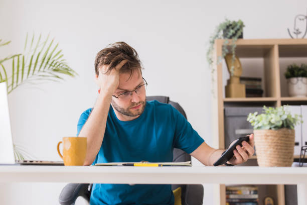 istock Nervous businessman using smart phone 2156928594