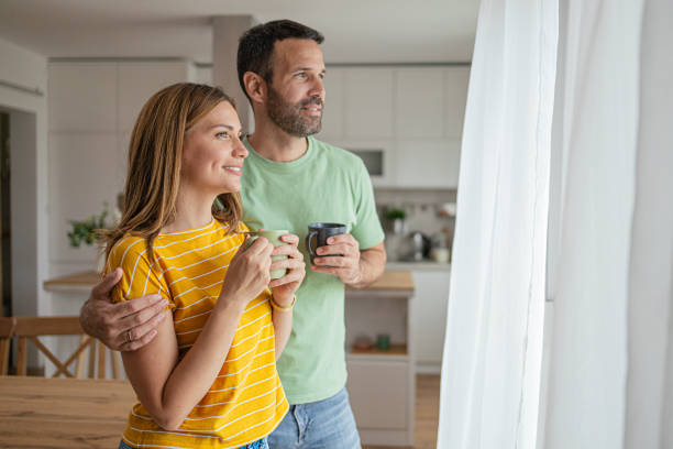 istock Lovely young couple drinking coffee at home 2156928994