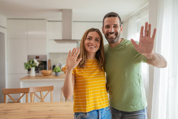 istock Happy couple waving to the camera 2156929680