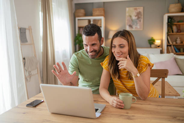 istock Couple at home making a reservation online using their laptop 2156930151