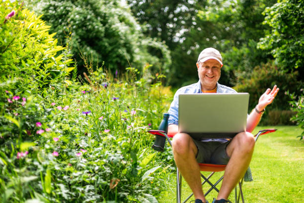istock Digital nomad on video conference call outdoors in beautiful garden 2156933979