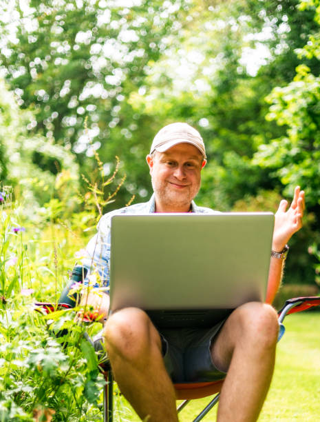 istock Digital nomad on video conference call outdoors in beautiful garden 2156934014