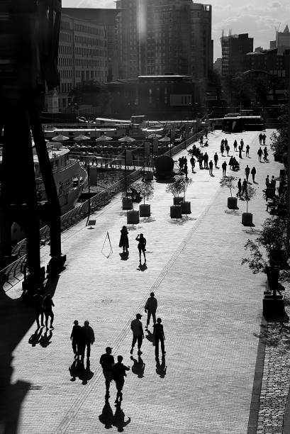 People walking along pedestrian zone in a sunny afternoon