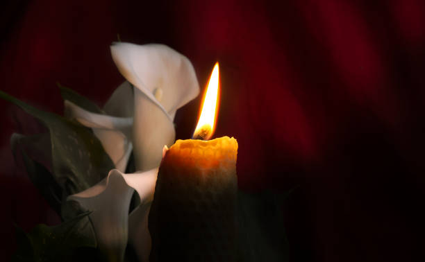 istock Burning wax candle in close up and white lily 2156936676