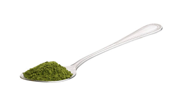 istock matcha green tea powder in spoon on white background 2156937680