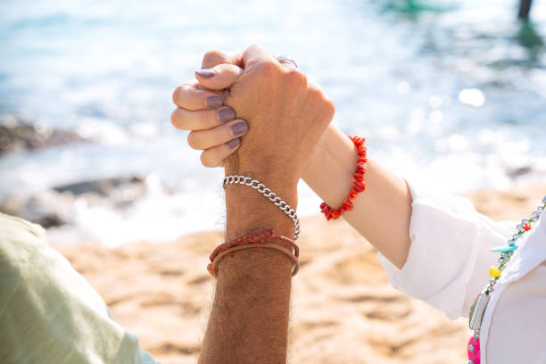 istock Unrecognizable friends high-fiving on the beach 2156938196