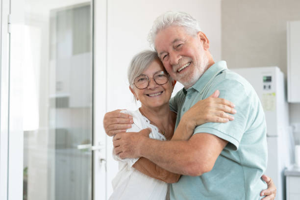 istock Handsome senior Caucasian couple hugging each other tenderly, exchanging cuddles and affection, concept of love, protection and care 2156940855